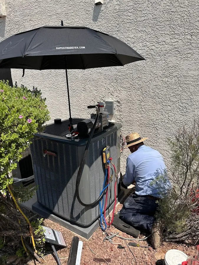 HVAC technician performing outdoor AC maintenance in Pewaukee